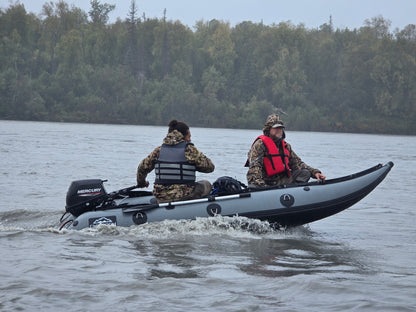 13ft Kaboat with 9.9hp outboard motor ready for remote Alaska river travel — lightweight and fuel-efficient inflatable.