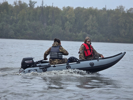 13ft Kaboat with 9.9hp outboard motor ready for remote Alaska river travel — lightweight and fuel-efficient inflatable.