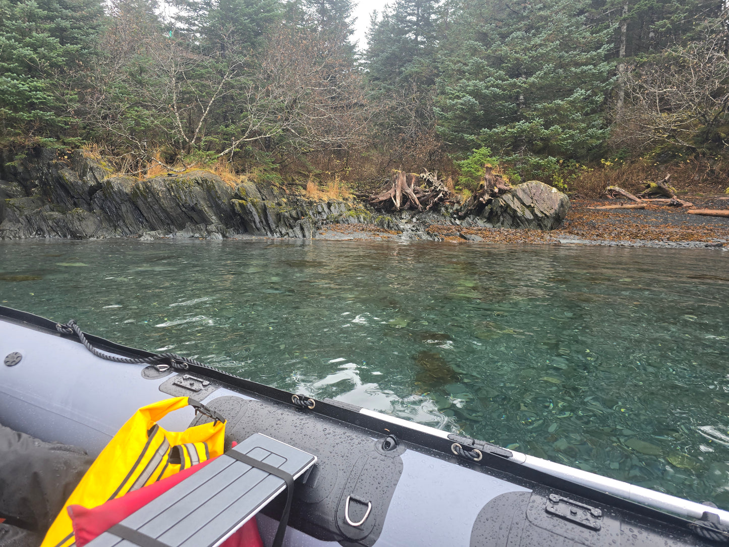 Stryker 420 RIB Jet Tunnel beached on rocky Alaska shoreline — rugged rigid-hull inflatable ideal for two people and gear.