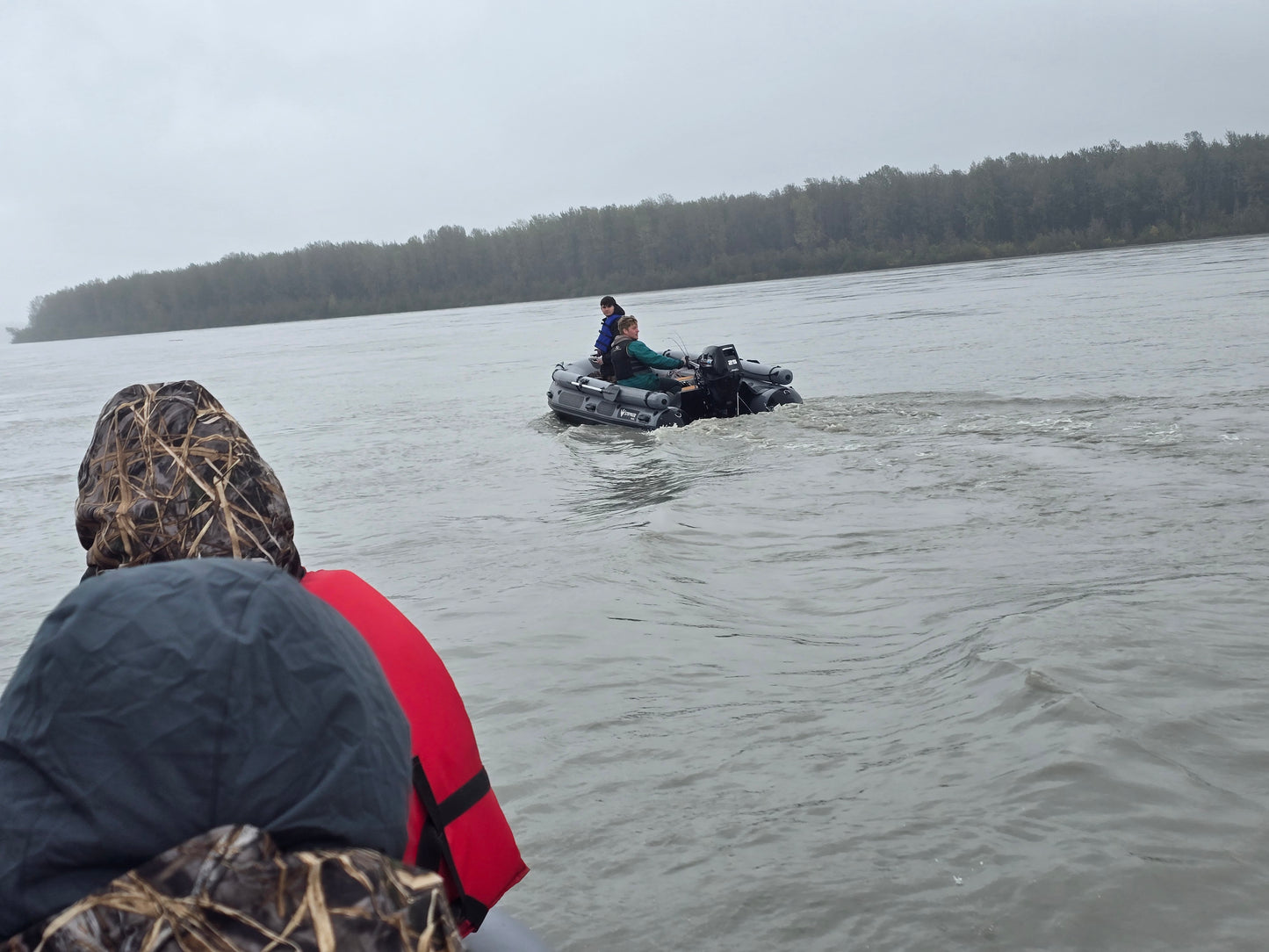 Stryker 420 Inflatable Jet Boat carrying two people and gear up a shallow Alaska river — powerful 50/35 HP Jet Outboard performance.