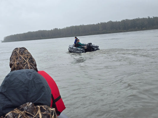 Stryker 420 Inflatable Jet Boat carrying two people and gear up a shallow Alaska river — powerful 50/35 HP Jet Outboard performance.