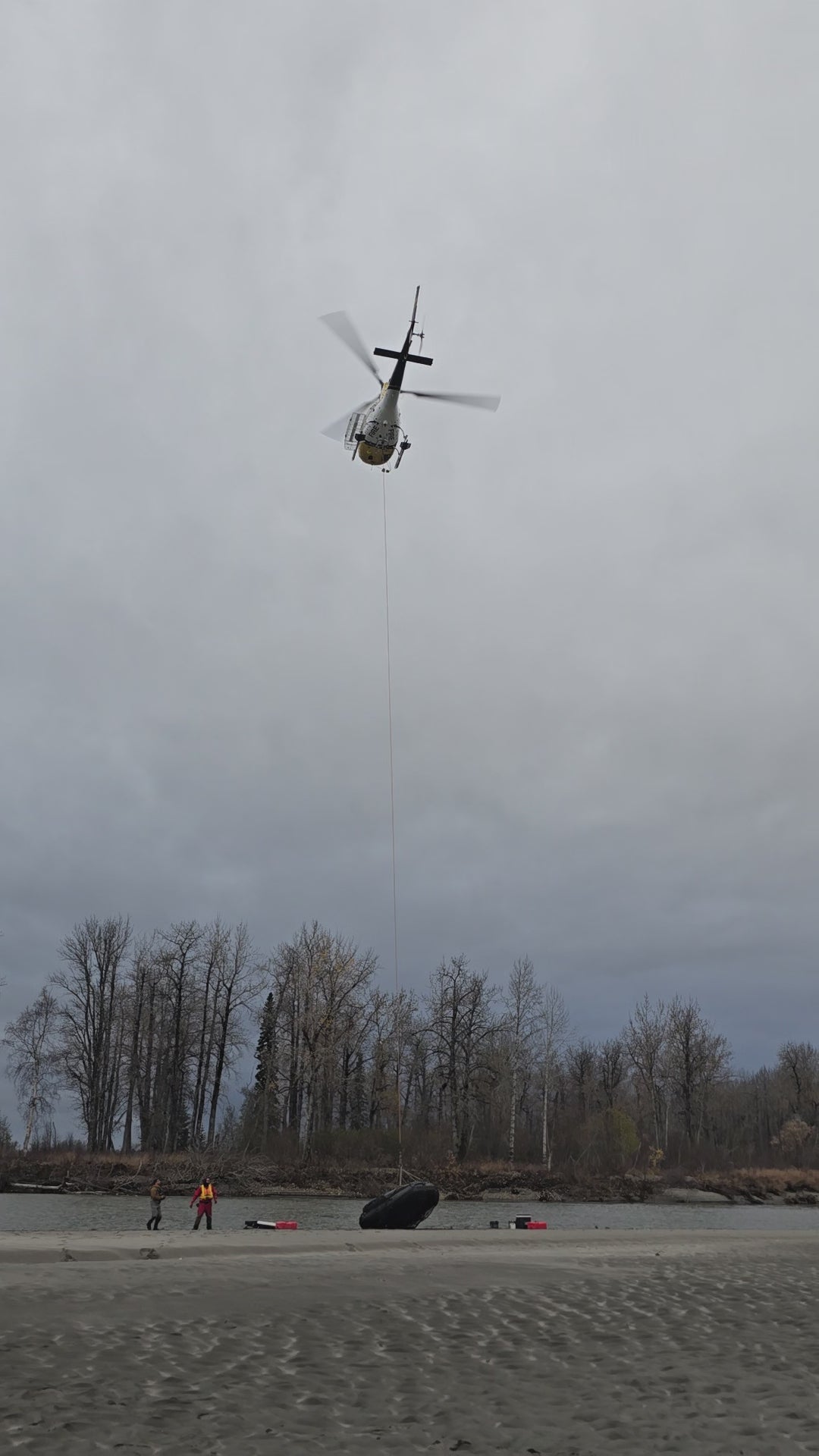 Pro Jet 470 Inflatable Jet Boat with 50/35 HP Jet Outboard being airlifted by helicopter for remote Alaska field deployment.