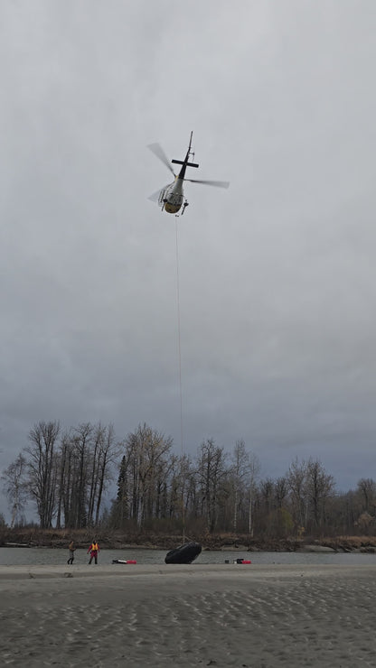 Pro Jet 470 Inflatable Jet Boat with 50/35 HP Jet Outboard being airlifted by helicopter for remote Alaska field deployment.