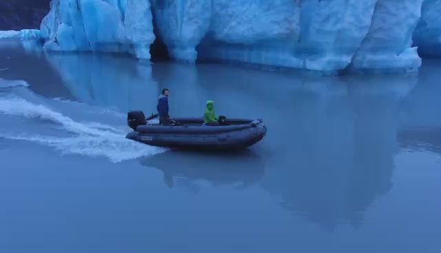 Load video: Pro Jet 470 Inflatable Jet Boat running through blue glacier waters near Spencer Glacier, showcasing 50/35 HP Jet performance.